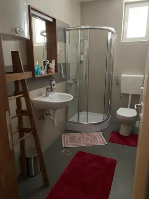 a bathroom with a shower and a sink and a toilet at 