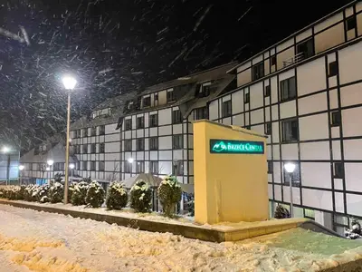 a mitzvah sign in front of a building in the snow at 