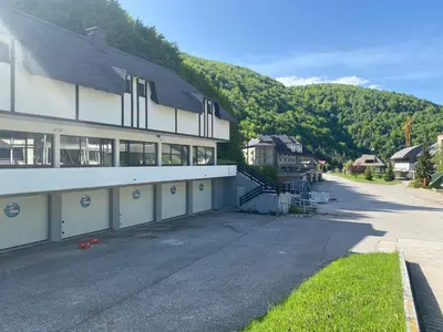 a building with two garage doors and a mountain at 