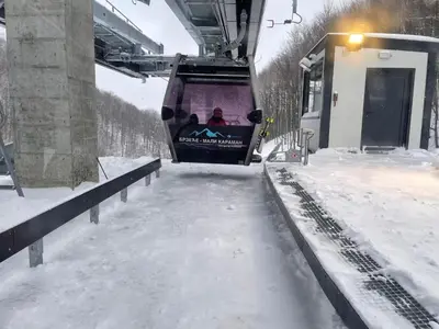 a ski lift with people on it in the snow at 