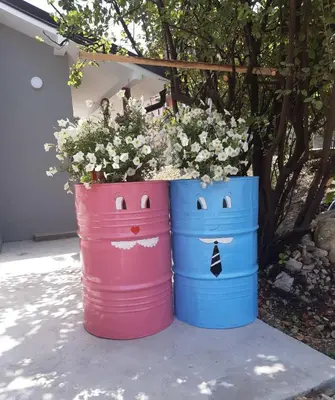 two buckets filled with flowers sitting next to each other at Apartman Ljiljan in Soko Banja