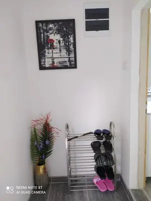 a rack of shoes in a room with a wall at Apartman Ljiljan in Soko Banja