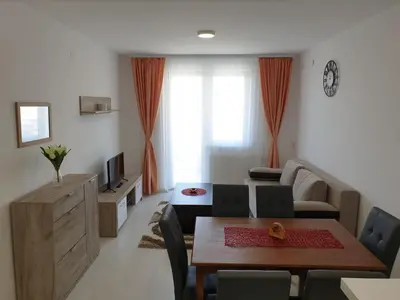 a living room with a table and a couch at Sokolux in Soko Banja