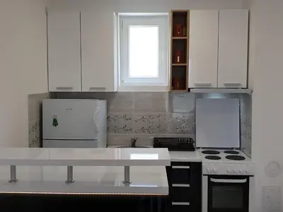 a kitchen with white appliances and a window at Sokolux in Soko Banja