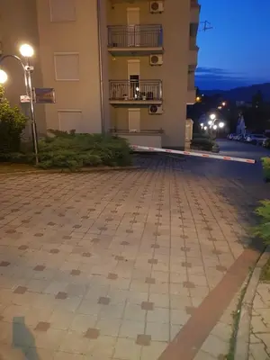 an empty street in front of a building at night at Apartman Jovanovic in Vrnjačka Banja