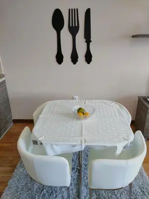 a white table with chairs and a plate of fruit on it at Apartman Jovanovic in Vrnjačka Banja