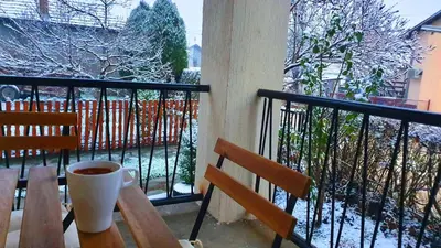 a cup of coffee sitting on a table on a balcony at Kuća Veneto & Free Parking in Soko Banja