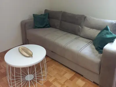 a living room with a couch and a table at Nina apartman in Vrnjačka Banja