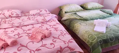 two beds sitting next to each other in a room at Smeštaj Ćirković in Vrnjačka Banja