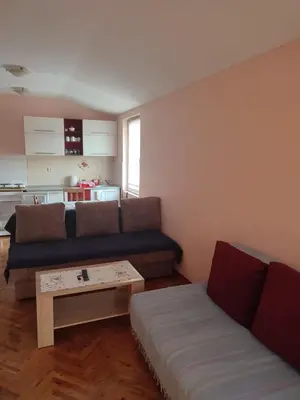 a living room with a couch and a coffee table at Smeštaj Ćirković in Vrnjačka Banja