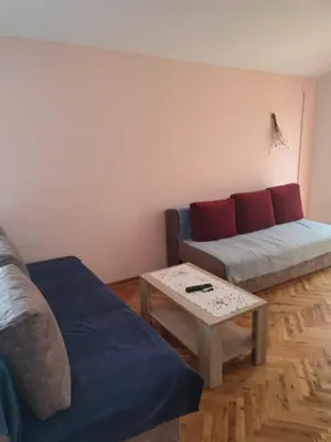 a living room with a couch and a coffee table at Smeštaj Ćirković in Vrnjačka Banja
