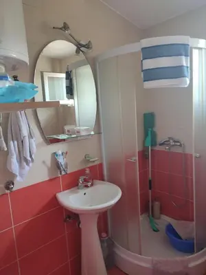 a bathroom with a sink and a mirror and a shower at Smeštaj Ćirković in Vrnjačka Banja