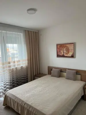 a bedroom with a large bed and a window at The View Apartment in Soko Banja