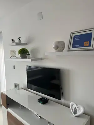 a flat screen tv sitting on top of a table at The View Apartment in Soko Banja