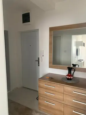 a bathroom with a dresser with a mirror on it at The View Apartment in Soko Banja