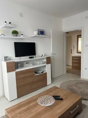 a living room with a tv and a coffee table at The View Apartment in Soko Banja