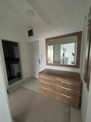 a bathroom with a wooden dresser and a mirror at The View Apartment in Soko Banja