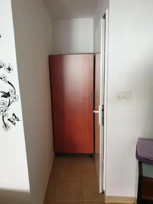 a hallway with a wooden door in a room at Apartmani Mile in Soko Banja