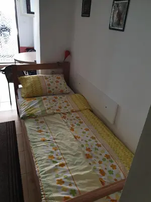 a bed sitting in a room with at Apartmani Mile in Soko Banja