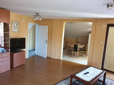 a living room with a television and a table at Apartmani Mile in Soko Banja