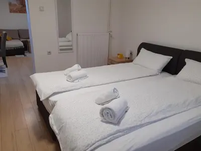 two beds with towels on them in a room at Apartman Nena in Pirot
