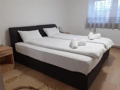 a bed with two teddy bears on top of it at Apartman Nena in Pirot