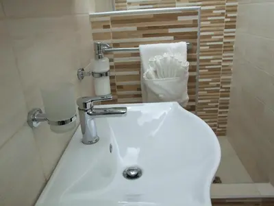 a bathroom with a white sink and a toilet at Apartman Nena in Pirot