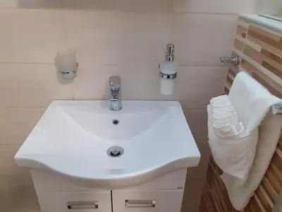 a bathroom with a white sink and a towel at Apartman Nena in Pirot