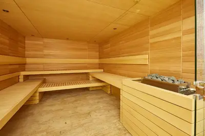 a sauna with wooden walls and wooden shelves at A Hoteli - Hotel Park in Vrnjačka Banja
