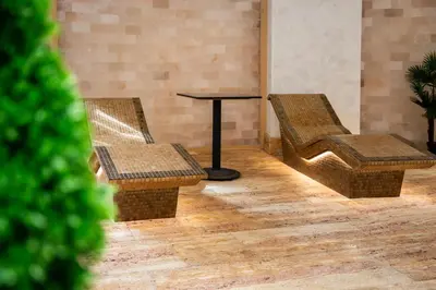 two chairs and a table in a room at A Hoteli - Hotel Park in Vrnjačka Banja