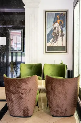 a dining room with green chairs and a table at A Hoteli - Hotel Park in Vrnjačka Banja