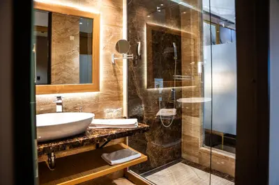a bathroom with a sink and a shower at A Hoteli - Hotel Park in Vrnjačka Banja