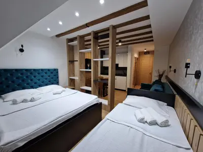 a bedroom with two beds with white towels at Apartments JAT Kopaonik in Kopaonik