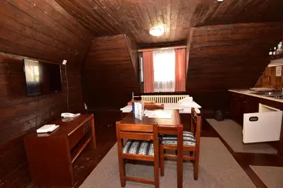 a room with a desk and a table in a kitchen at Apartments JAT Kopaonik in Kopaonik