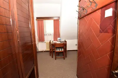 a room with a table and chairs and a door at Apartments JAT Kopaonik in Kopaonik