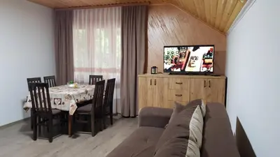 a living room with a couch and a table with a television at Kuca Stojanovica Topli Do in Pirot