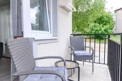 a porch with two chairs and a window at Panorama Lux in Soko Banja