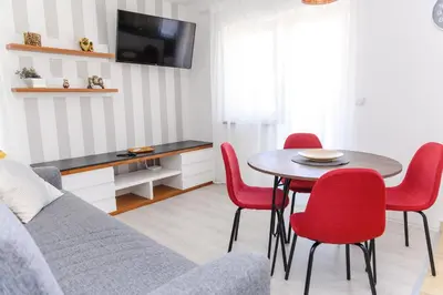 a living room with a table and red chairs at Panorama Lux in Soko Banja