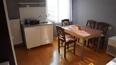 a kitchen with a table and a table and chairs at Casablanca in Niš