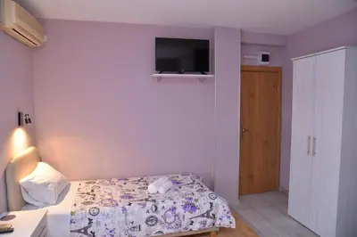 a bedroom with a bed and a tv on the wall at Casablanca in Niš