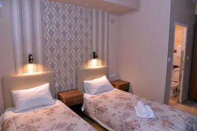 a hotel room with two beds and two lamps at Casablanca in Niš