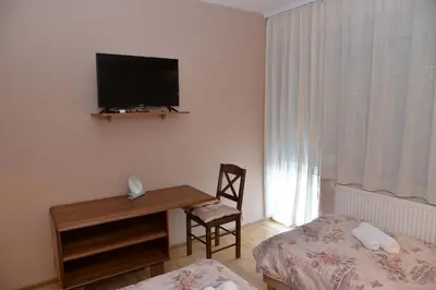 a room with a desk and a television on the wall at Casablanca in Niš