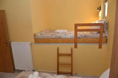 a room with two bunk beds and a ladder at Casablanca in Niš