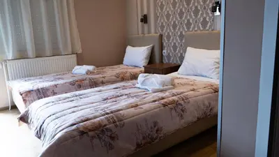 two beds sitting next to each other in a bedroom at Casablanca in Niš
