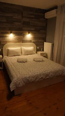 a bedroom with a bed with two towels on it at Casablanca in Niš
