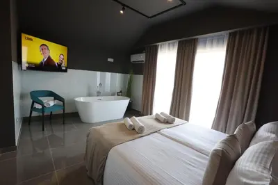 a bedroom with a large bed and a bath tub at 9 apartments in Jagodina