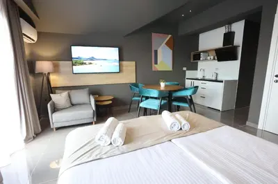 a hotel room with a bed and a dining room at 9 apartments in Jagodina