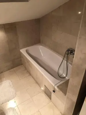 a bathroom with a bath tub in a room at Loli Caffe Apartment in Prokuplje