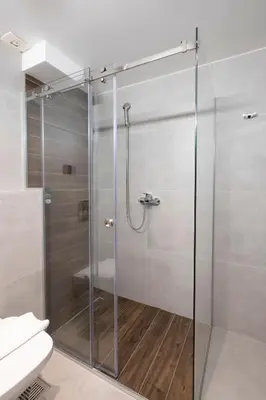 a shower with a glass door in a bathroom at Mila apartmani Kopaonik in Kopaonik