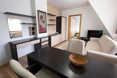 a living room with a table and a couch at Mila apartmani Kopaonik in Kopaonik